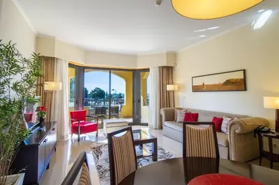 a living room with a couch and a table at Apartamento Vitoria in Vilamoura