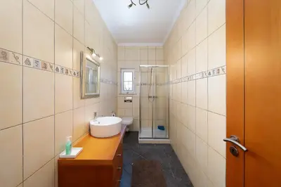 a bathroom with a sink and a toilet and a shower at Casa Coelho in Albufeira