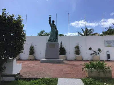 a statue of a woman in front of a white wall at Old Town, Bay View Apartment in Albufeira