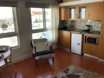 a kitchen with a table and a chair in a room at Old Town, Bay View Apartment in Albufeira