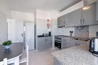 a kitchen with white appliances and a counter top at 1 Bedroom Seaview Apartment in Quarteira