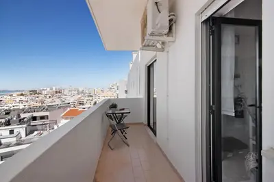 a balcony with a view of a city at 1 Bedroom Seaview Apartment in Quarteira