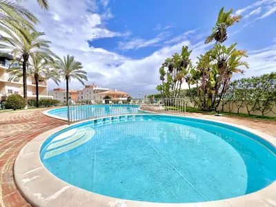 a large swimming pool with palm trees in the background at Albufeira Modern 6 With Pool by Homing in Albufeira