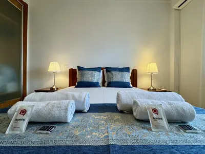 a hotel room with two beds and a window at Albufeira Modern 6 With Pool by Homing in Albufeira