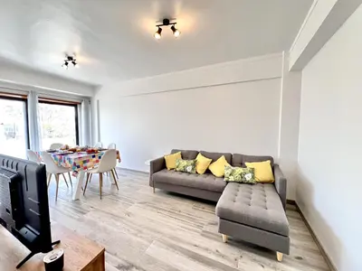 a living room with a couch and a table at Quarteira Brightness by Homing in Quarteira