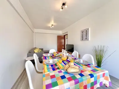 a dining room with a colorful table and chairs at Quarteira Brightness by Homing in Quarteira