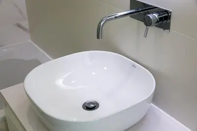 a white toilet with a sink in a bathroom at Casa Bella in Loulé