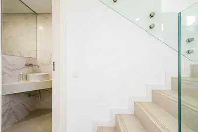 a bathroom with stairs and a shower and a sink at Casa Bella in Loulé