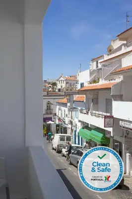a sign for a clean and safe shop on a city street at DownTown Albufeira beach Apartment in Albufeira