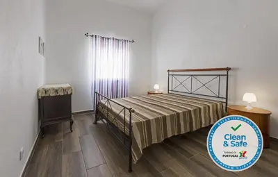 a bedroom with a bed and a window at DownTown Albufeira beach Apartment in Albufeira