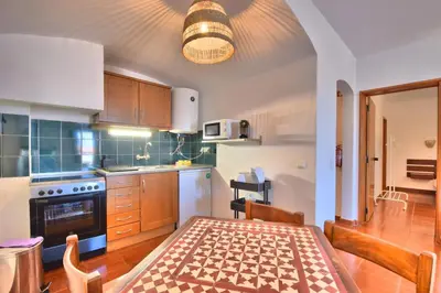 a kitchen with a table and a dining room at BeGuest Oura Vilanova Apartment in Albufeira