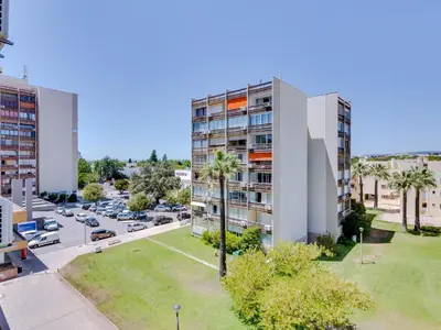 an aerial view of a building with a parking lot at T1 Edificio Loulé - centro de Vilamoura in Vilamoura