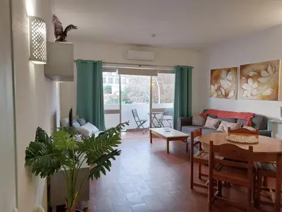 a living room with a table and a couch at BeGuest Sea Breeze Apartment in Albufeira