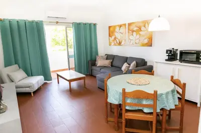 a living room with a table and a couch at BeGuest Sea Breeze Apartment in Albufeira