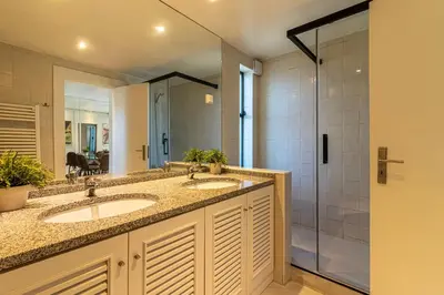 a kitchen with a black refrigerator and a counter at BmyGuest - Vilamoura Golf Villa in Vilamoura