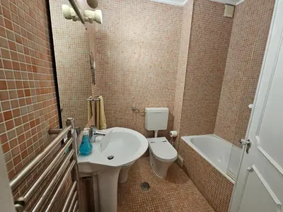 a bathroom with a sink and a toilet and a tub at Blife Batalya private rooms in Faro