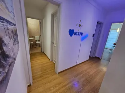 a room with a white wall with a heart sign on it at Blife Batalya private rooms in Faro