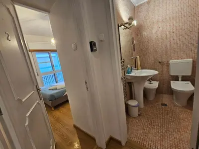 a bathroom with a toilet and a sink at Blife Batalya private rooms in Faro