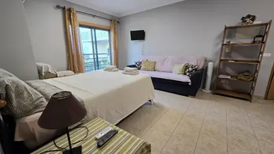 a living room with a bed and a couch at Beautiful Studio Letícia in Roja- Pé
