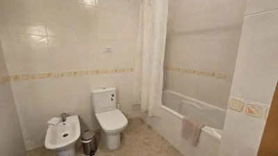 a bathroom with a toilet and a bath tub at Beautiful Studio Letícia in Roja- Pé