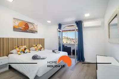 a bedroom with a bed and a window with the words home holidays at #305 Albufeira Sea House by Home Holidays in Albufeira