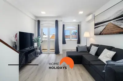 a living room with a couch and a tv at #305 Albufeira Sea House by Home Holidays in Albufeira