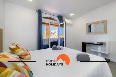 a bedroom with a bed with a home holidays sign on it at #305 Albufeira Sea House by Home Holidays in Albufeira