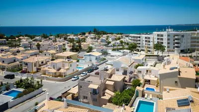 an aerial view of a city with houses and the ocean at Villa Terramar - Golden & Salty in Guia