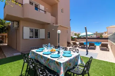 a table with plates and glasses on a patio at Villa Terramar - Golden & Salty in Guia