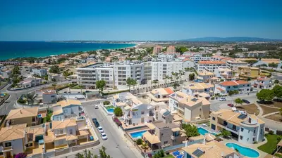 an aerial view of a city with houses and the ocean at Villa Terramar - Golden & Salty in Guia