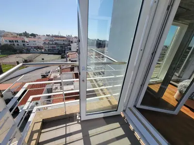 a balcony with a view of a building at Newly Remodeled 2BD Brilliant Oura Strip 9min beach in Albufeira