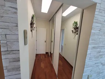 a hallway in a building with a stone wall at Newly Remodeled 2BD Brilliant Oura Strip 9min beach in Albufeira
