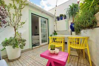 a bathroom with a sink and a toilet and a mirror at Arty city house Casa Da Selva in Faro