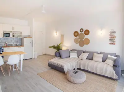 a living room with a couch and a table at Boho house, Albufeira in Albufeira