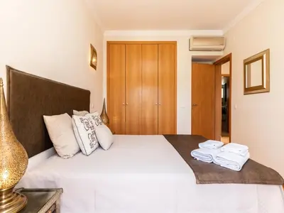 a bedroom with a bed with white sheets and towels at NEW! Villa Balaia K-11 in Branqueira