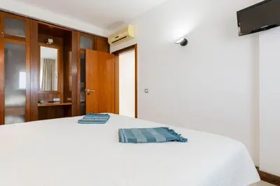 a bedroom with a bed with two pillows on it at Sea-Stretch viewing SuperKing flat by BentoBox in Albufeira