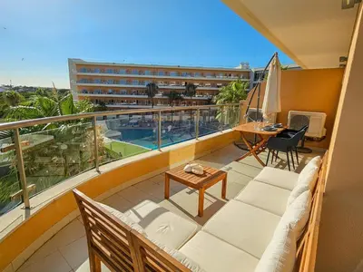 a living room with a couch and a table at Sea-Stretch viewing SuperKing flat by BentoBox in Albufeira