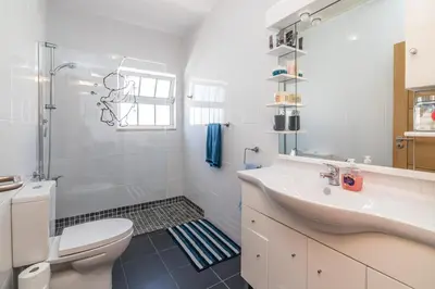 a white bathroom with a sink and a toilet at Villa Mia - Peerless Bond in Albufeira