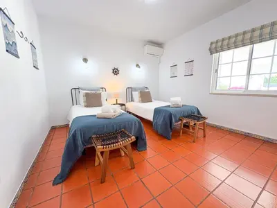 two beds in a room with orange tiles at Villa Mia - Peerless Bond in Albufeira