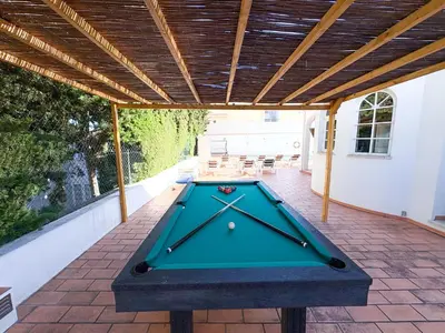 a pool table on the back patio of a house at Villa Mia - Peerless Bond in Albufeira