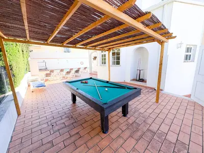 a pool table in the middle of a patio at Villa Mia - Peerless Bond in Albufeira