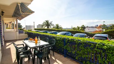 a table and chairs on a balcony with a parking lot at Oura Sunrise 3B Apartment by Stay ici Algarve Holiday Rental in Albufeira