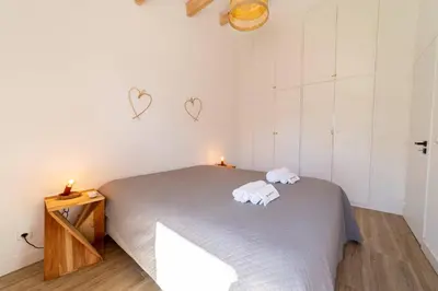 a bedroom with a bed with two towels on it at Falésia Coast Villa by HelloVacations in Albufeira