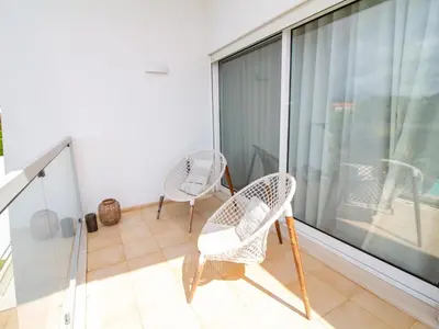 two chairs sitting on the balcony of a house at Serenity 03 House by Stay ici Algarve Holiday Rental in Albufeira