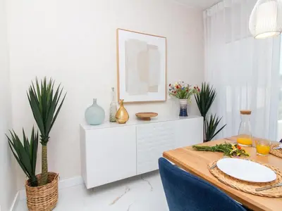 a dining room with a table and a picture on the wall at Serenity 03 House by Stay ici Algarve Holiday Rental in Albufeira
