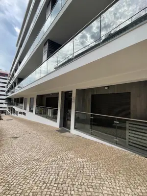 a large building with large windows on the side of it at Apartamento Noronki - Altos do Forte Novo in Quarteira