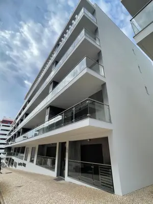 a white building with balconies on the side of it at Apartamento Noronki - Altos do Forte Novo in Quarteira