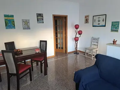 a living room with a table and chairs and a couch at Lovely flat in the center in Faro