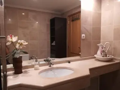 a bathroom with a sink and a large mirror at Lovely flat in the center in Faro