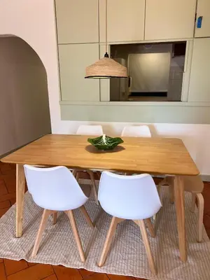 a room with a white chair and a door at T2 Monte Sol HsRentals Vilamoura in Vilamoura
